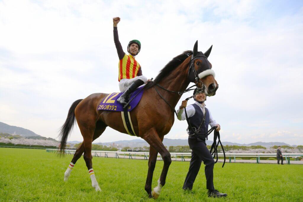 Joao Moreira celebrates after riding Stellenbosch to victory in the G1 Oka Sho at Hanshin
