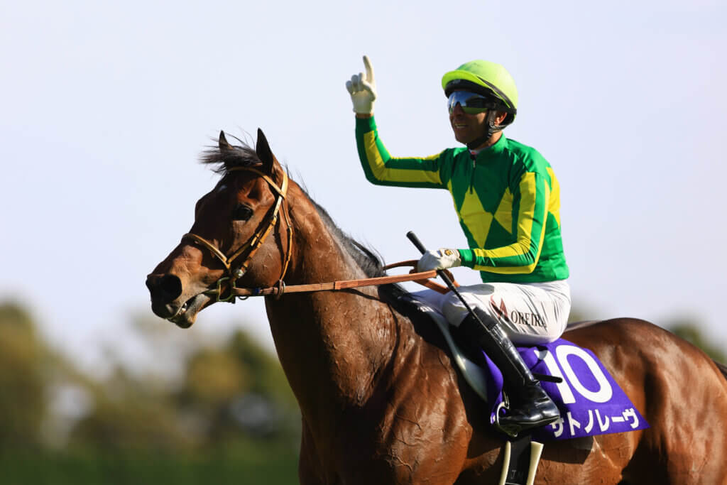 Joao celebrating aboard Satono Reve after G1 win