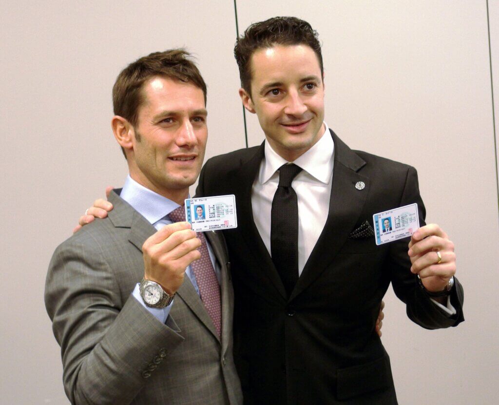 Jockeys Mirco Demuro and Christophe Lemaire display their full-time JRA licences in Tokyo, 2015