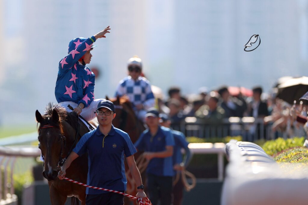 Dylan Mo throwing his goggles to the Sha Tin crowd after a win on Winning Wing