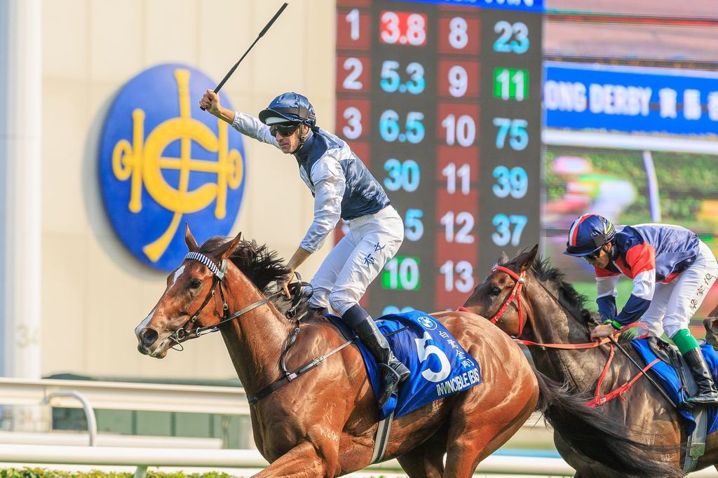 Hugh Bowman celebrates crossing the line to win the 2026 Hong Kong Derby
