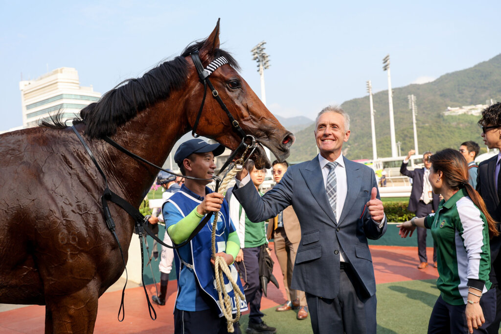 Mark Newnham celebrates after his first Hong Kong Derby win