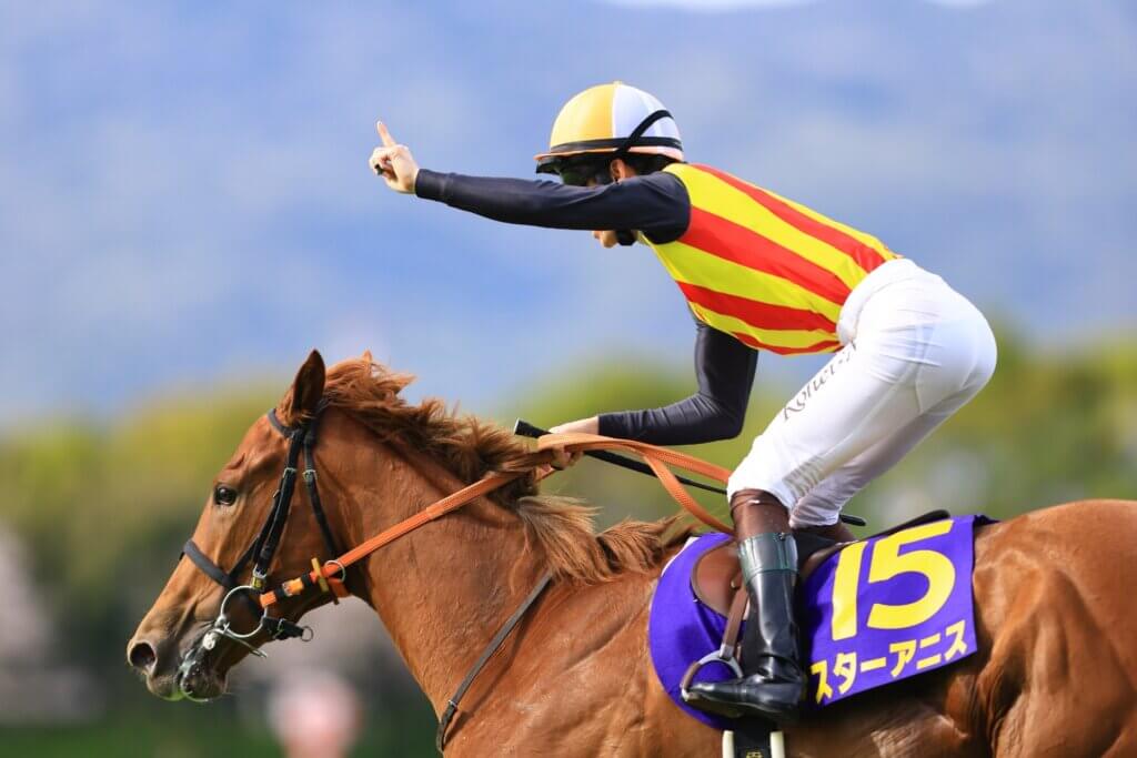 Kohei Matsuyama raises a finger to the sky as he wins the G1 Oka Sho aboard Star Anise