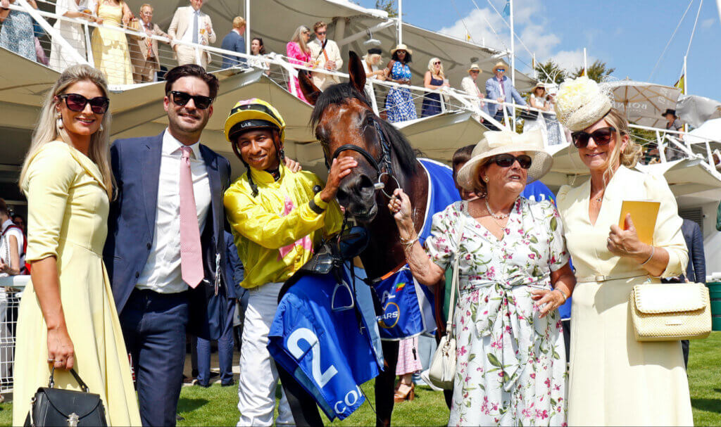 Mother and son Julie and Charlie Rosier pose for a photo after Dr Rascal's Vintage Stakes win at Goodwood