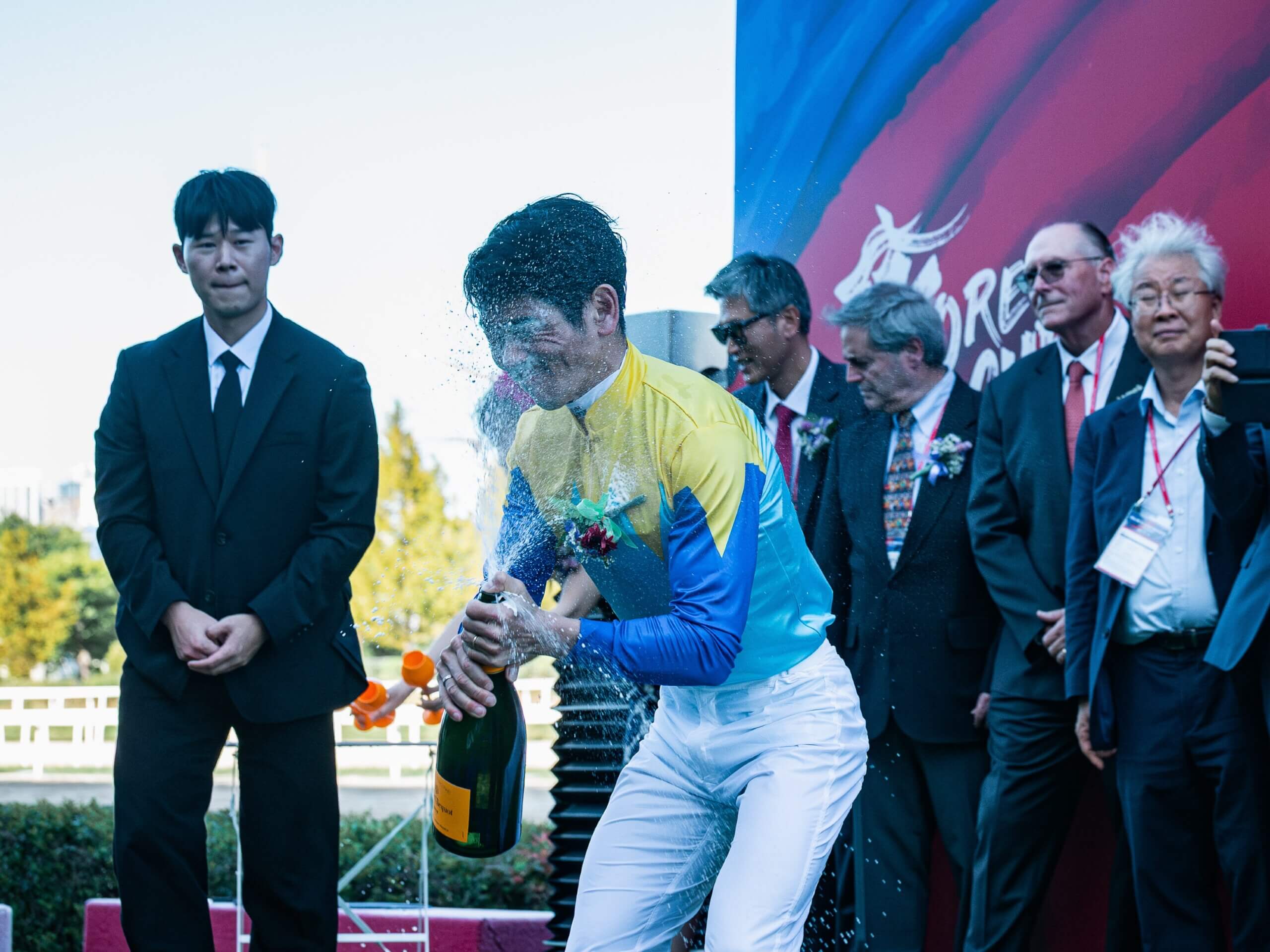 Keita Tosaki copping champagne in the face in Korea