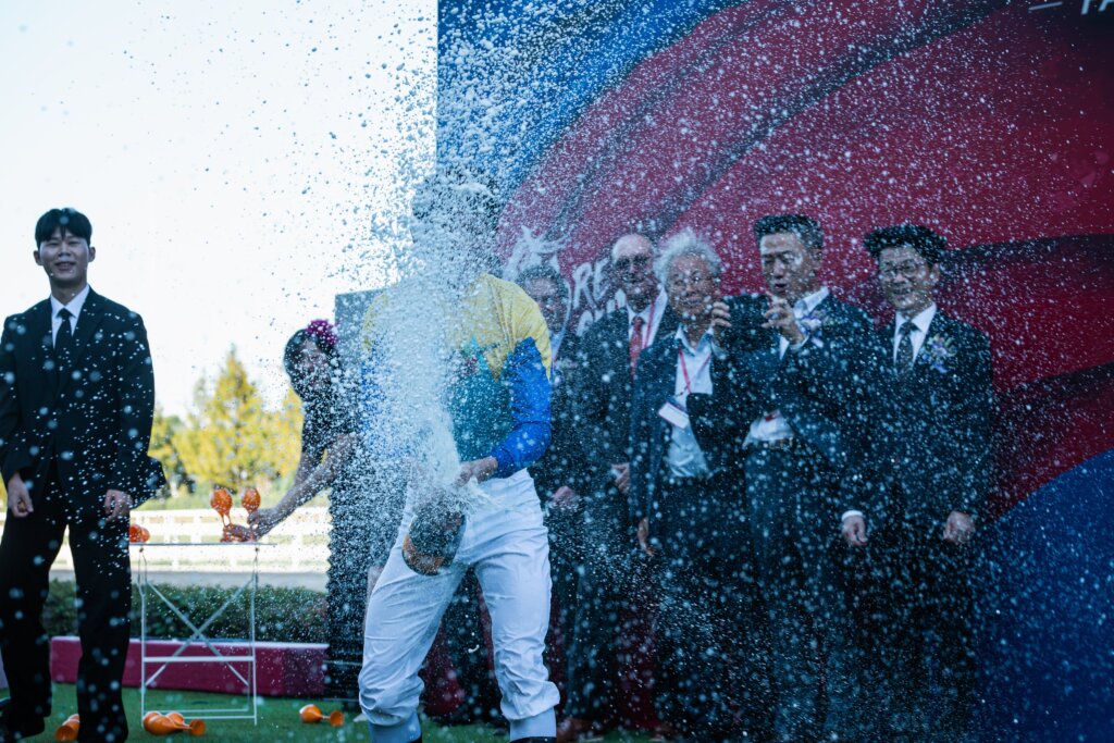Keita Tosaki spraying champagne everywhere during Korea Sprint celebration