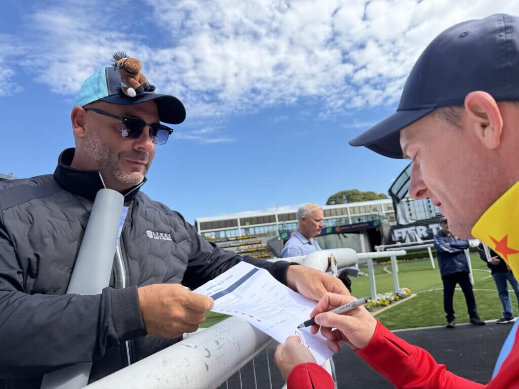 Zac Purton signing an autograph for a fan